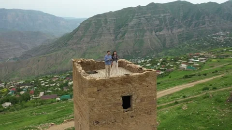 Travellers standing on top of ancient tower in Goor village in Dagestan 스톡 동영상 265010984