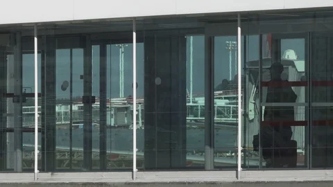 Travellers walk through jet bridge to board waiting plane Stock Footage 119822960