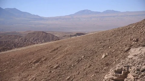 Travellers walking in mountain path on a sunny day Stock Footage 79786176