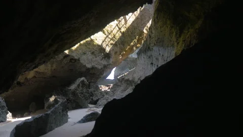 Travelling in a cave between the rocks of a beach, in Bali, Indonesia Stock Footage 222374437