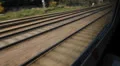 Travelling by train in the UK. Train tracks. HD Footage