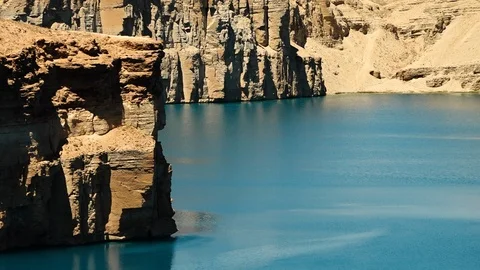 Travertine cliffs overlooking blue lake. Stock Footage 106354355