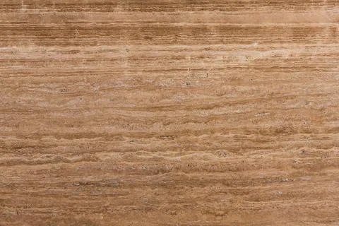 Travertine gold. Pattern of natural origin on the surface of the stone, close-up Stock Photos
