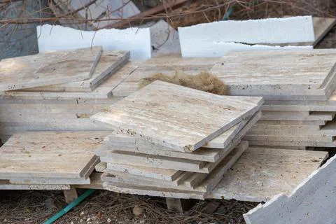 Travertine stone tiling slabs stacked for construction project Fotos Stock