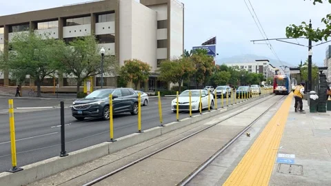 TRAX light rail train arriving at Library Station in downtown Salt Lake City Stock Footage 328388738