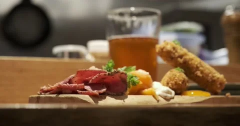 A tray of appetizers and beer in the background 動画素材 237206041