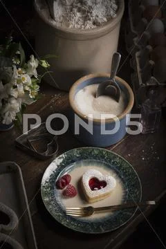 A tray of baked heart shaped biscuits Stock Photos