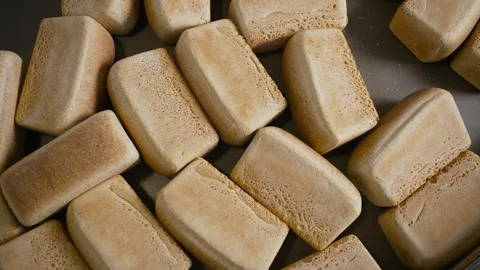 A tray of bread is shown with many different shapes and sizes. The bread is Stock Footage 317455293