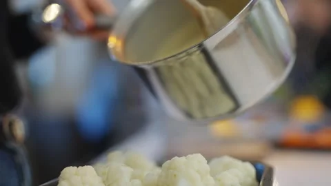 A tray of cauliflower is steaming on a counter Stock Footage 295368975