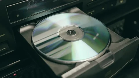 A tray with a compact disc is inserted into CD player and a hand presses play Video stock 287951729