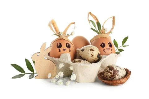 Tray with creative Easter eggs, nest, leaves and flowers isolated on white ba Stock Photos