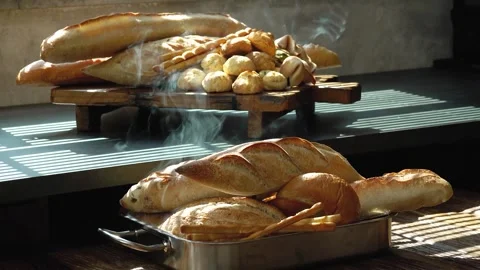 Tray Filled with Freshly Baked Bread Releasing Steam Close Up 動画素材 335732960