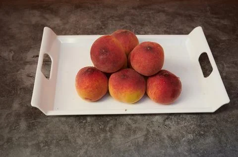 A tray of fruit with a white background Stock Photos