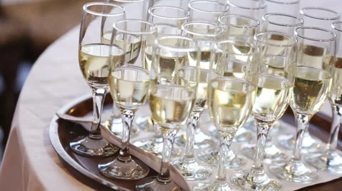 A tray of glasses with bubbling champagne Stock Footage 63864173