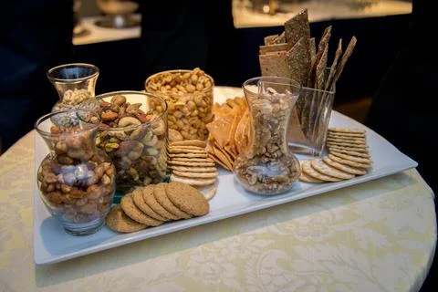 Tray of nuts crackers cookies on a table at a thanksgiving dinner Stock Photos