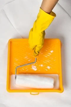 Tray for paint and a hand with roller Stock Photos