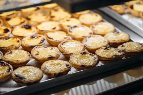 A tray with pasteis de nata, typical Portuguese egg tart pastries on a cafe s Stock Photos