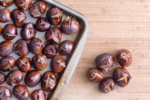 Tray of roasted chestnuts on table Stock Photos