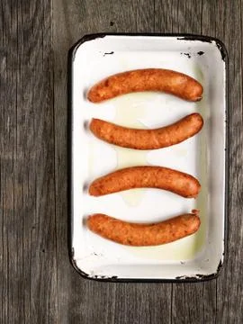 Tray of rustic uncooked sausages Stock Photos