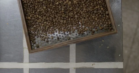 Tray shaking roasted coffee beans RED 4K slow motion tight Stock Footage 102927020