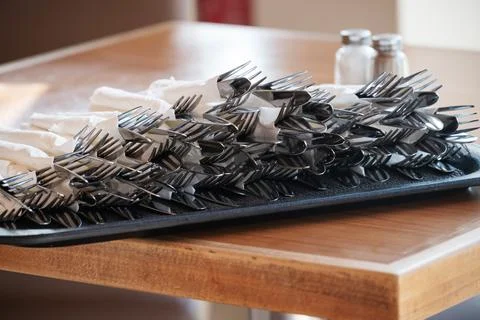 On Tray On Table Are Prepared Sets Of Eating Utensils - Knifes And Forks In Stock Photos