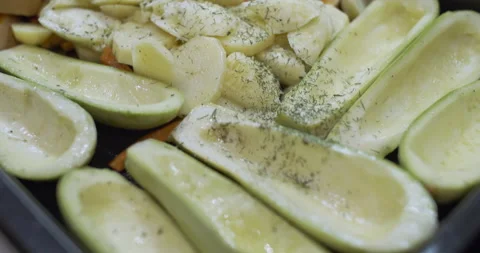 A tray with vegetables and food is sprinkled with spices. Baked vegetables. Slow Video stock 145536053