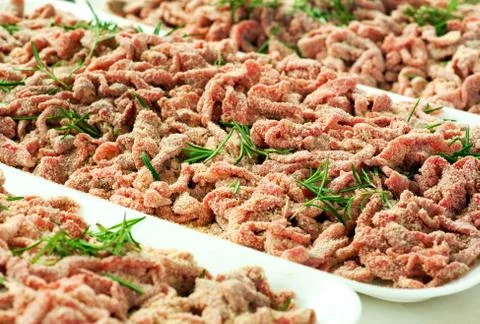 Trays of breaded strips of raw beef Stock Photos