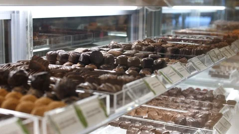 Trays of chocolate bonbons on display in a counter Video stock 105223553