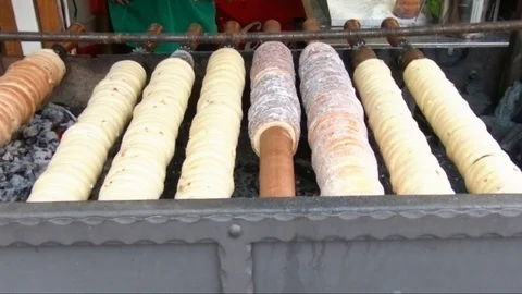 Trdelnik chimney cake baking on a coal spit roast Stock Footage 104587308