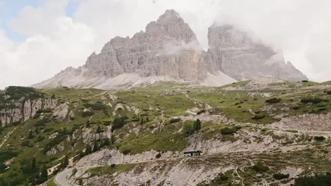 Tre Cime di Lavaredo massive limestone towers rise through mist rugged alpi.. Stock-Footage 332264090