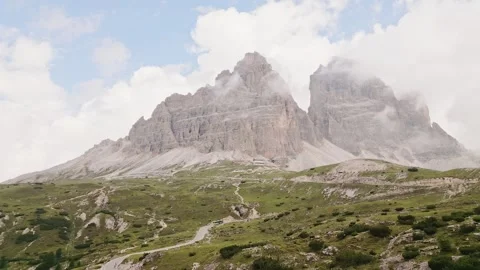 Tre Cime di Lavaredo massive limestone towers rise through mist rugged alpi.. Vídeo Stock 332272345