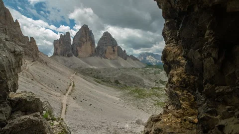 Tre Cime di Lavaredo rocky peaks Dolomites slider timelapse from cave, 8k, Italy Video stock 247642900