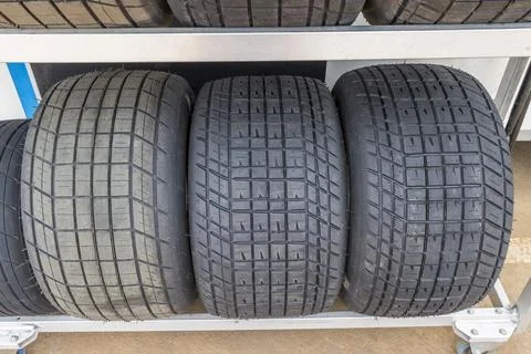 Tread pattern on large rubber speedway tyres in the pit area before a race Stock Photos