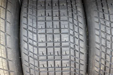 Tread pattern on large rubber speedway tyres in the pit area before a race Foto stock