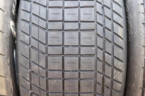 Tread pattern on large rubber speedway tyres in the pit area before a race Stock Photos