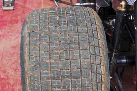 Tread pattern on large rubber speedway tyres in the pit area before a race Foto stock
