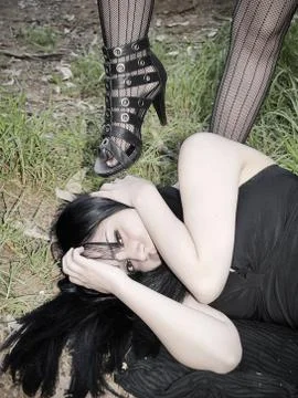 Treading a woman's head Stock Photos