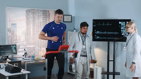 Treadmill test: running athlete on racetrack suddenly falling down because of Stock Footage 114084367