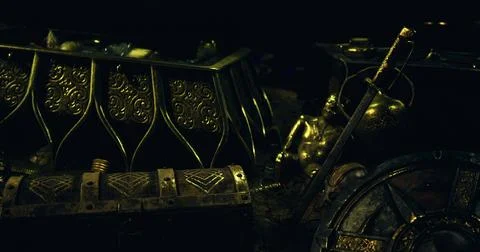 Treasure chest filled with ancient artifacts and gold in a dark setting Stock Illustration