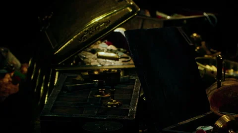 Treasure chest filled with various items in a dark room Stock Footage 339866504