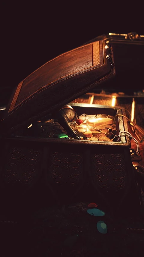 Treasure chest open with various items inside shining in low light Stock Footage 343179812