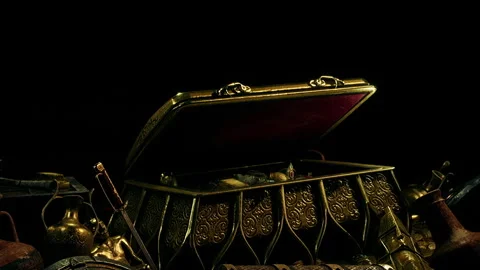 Treasure chest with various items displayed in a dark setting Stock Footage 343519800