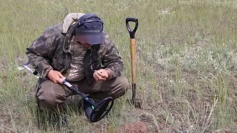 Treasure hunter in the field with a metal detector Stock Footage 109455935