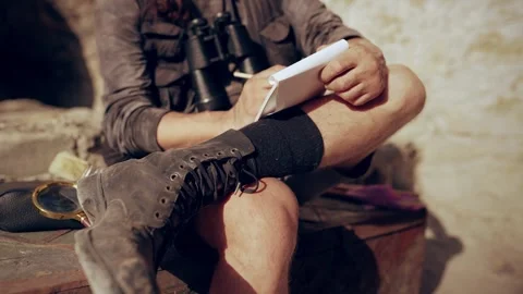 Treasure hunter makes sketches in a notebook Stock Footage 280356760