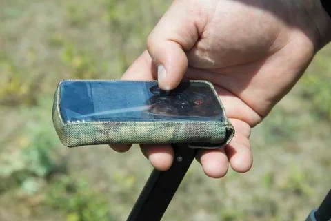 Treasure hunter with metal detector, selective focus Stock Photos