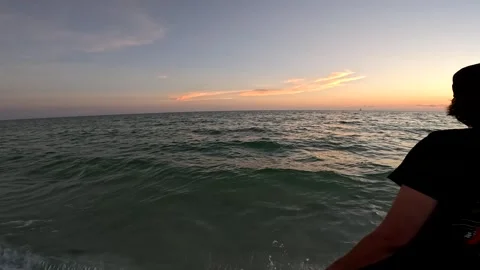 Treasure Island beach at sunset young man walks by Stock Footage 247739924
