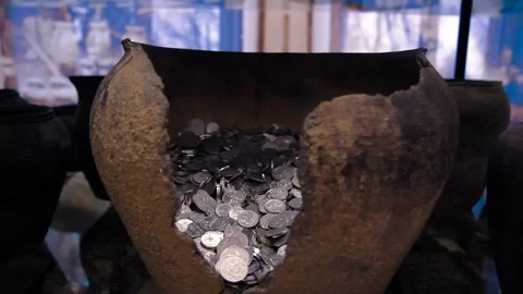 Treasure, many silver coins in a smashed, ancient clay pot, in a museum Stock Footage 247368969