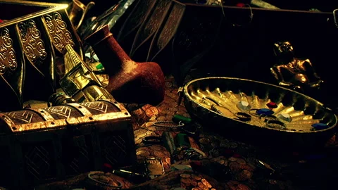 Treasures discovered on a dark table filled with old artifacts and coins Stock Footage 340606648