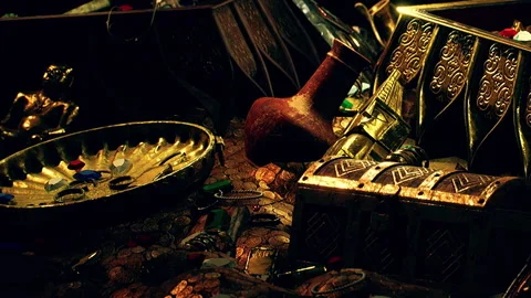 Treasures on a table with ancient coins and decorative items in a dim light Stock Footage 339460006