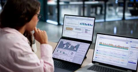 Treasury Manager Analyzes Multi-currency Cash Flow Using Dashboard Software. Stock Photos